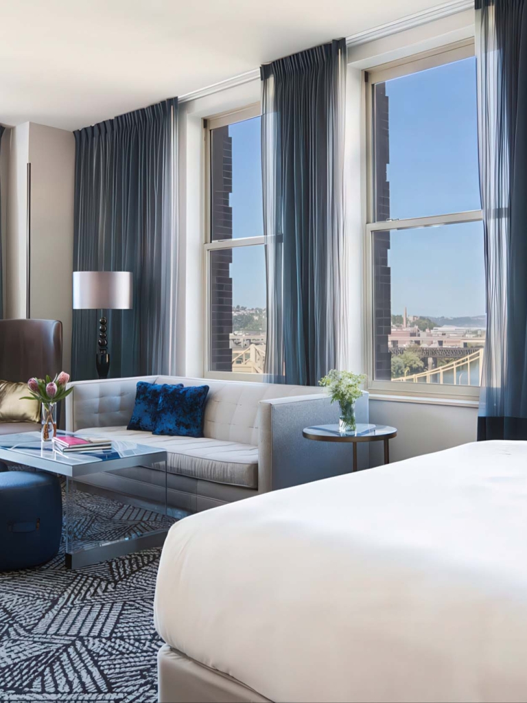 Hotel accommodations with large windows and a comfortable couch