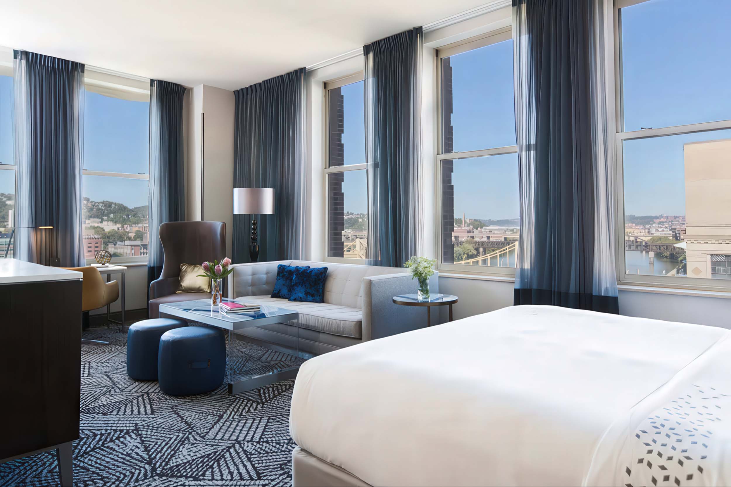 Hotel accommodations with large windows and a comfortable couch
