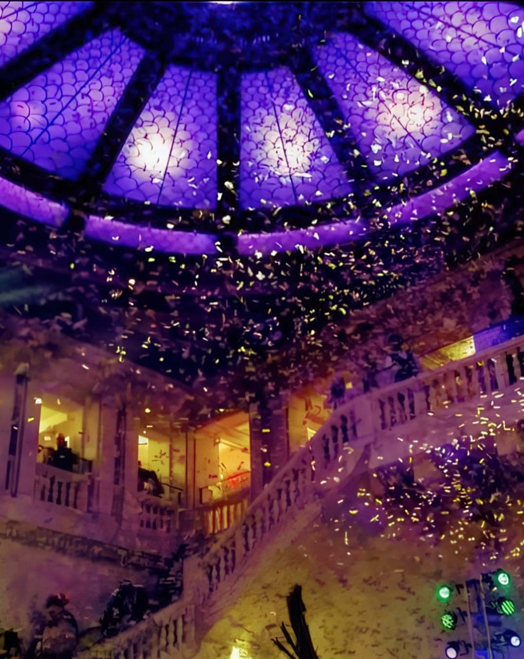 Confetti falls from above in a hotel lobby