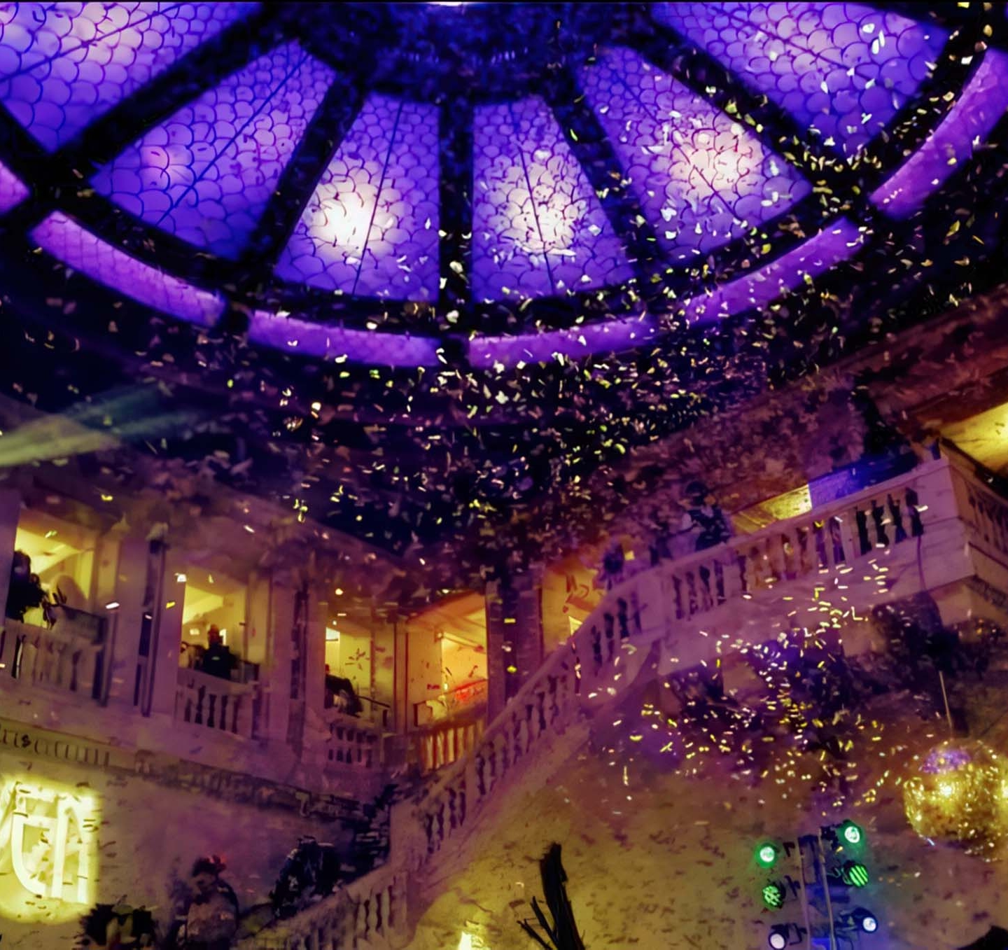 Confetti falls from above in a hotel lobby
