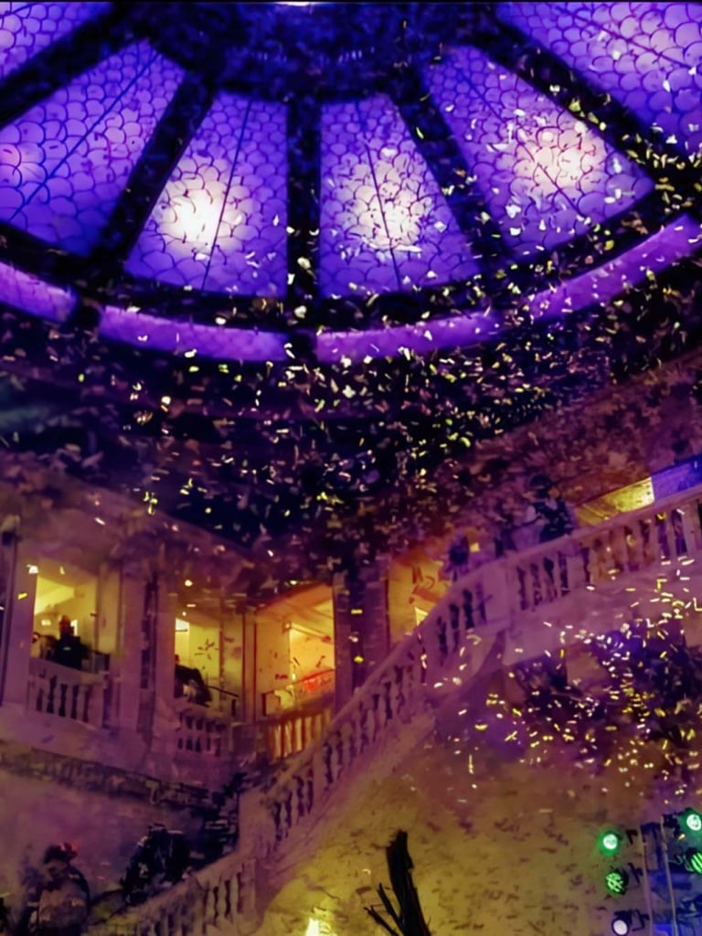 Confetti falls from above in a hotel lobby