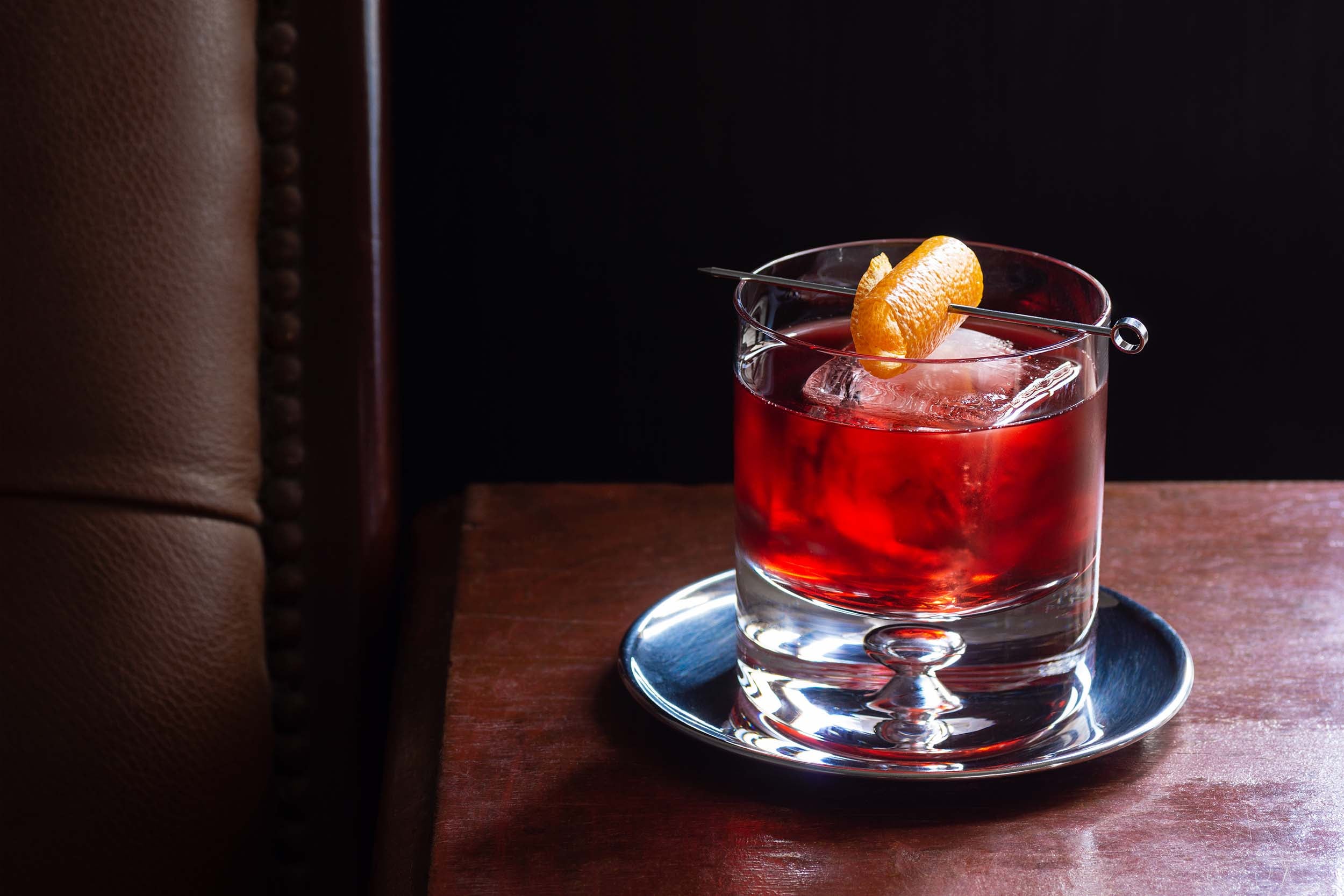 A negroni sits on a metal tray