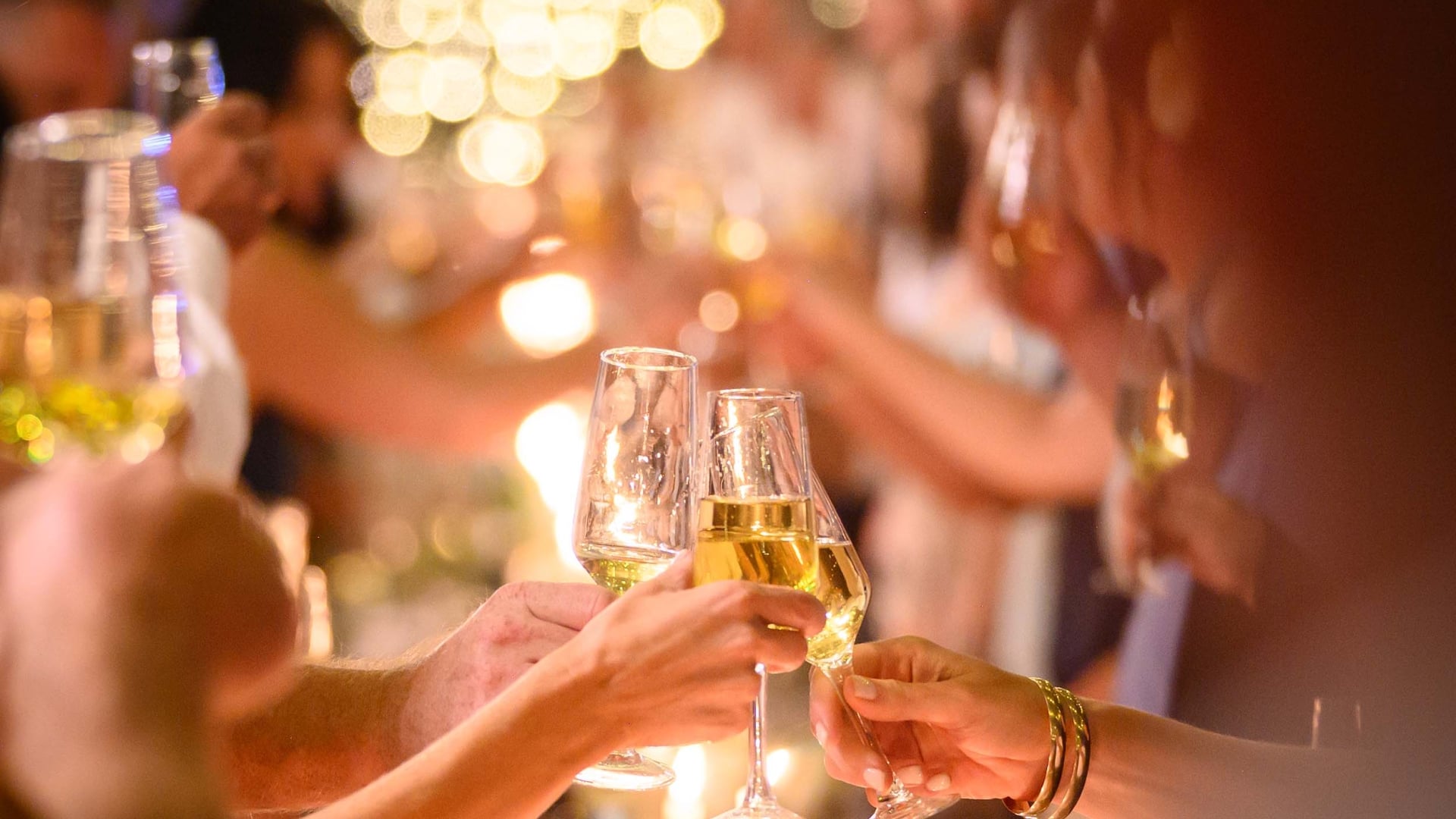 A group clinking champagne glasses at an event
