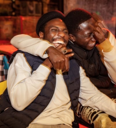Two friends hugging and smiling