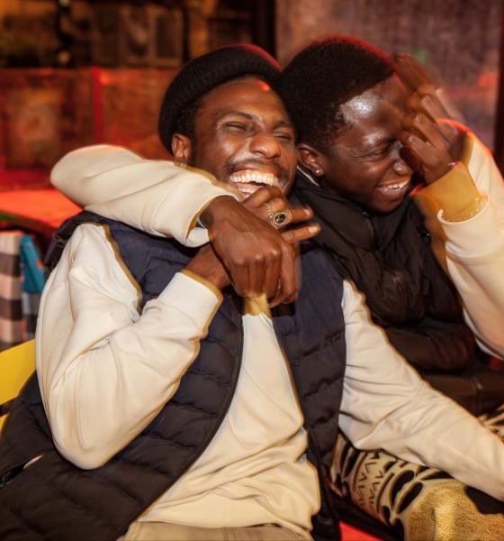 Two friends hugging and smiling