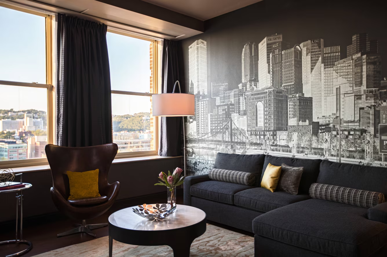 A seating area with a wall mural and a city view