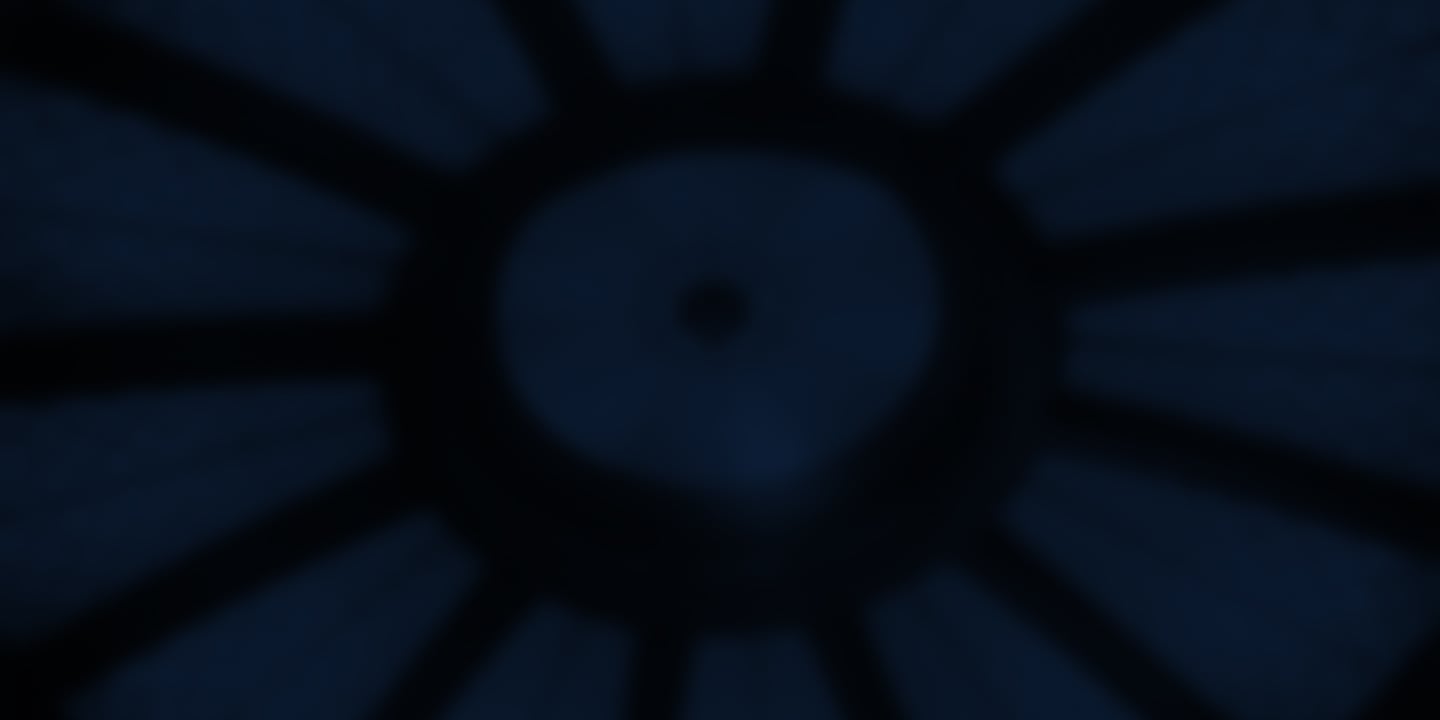 A dark blue, blurry image shows a central circular area with radiating dark lines, resembling a spoked wheel or aperture.
