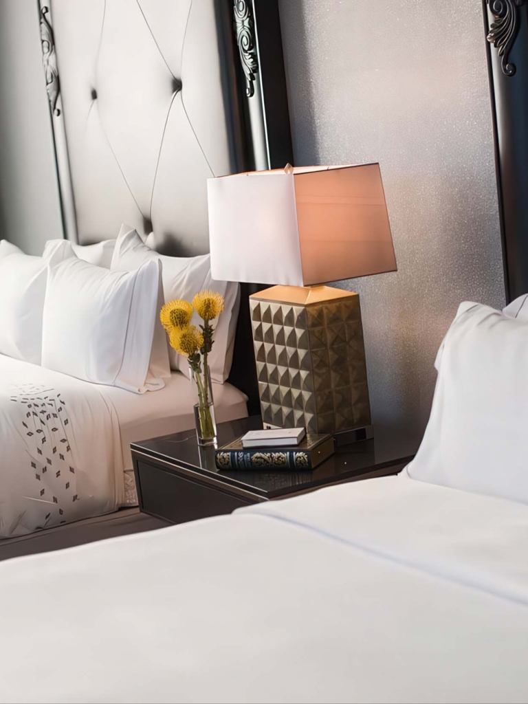 Two queen beds with a nightstand between them