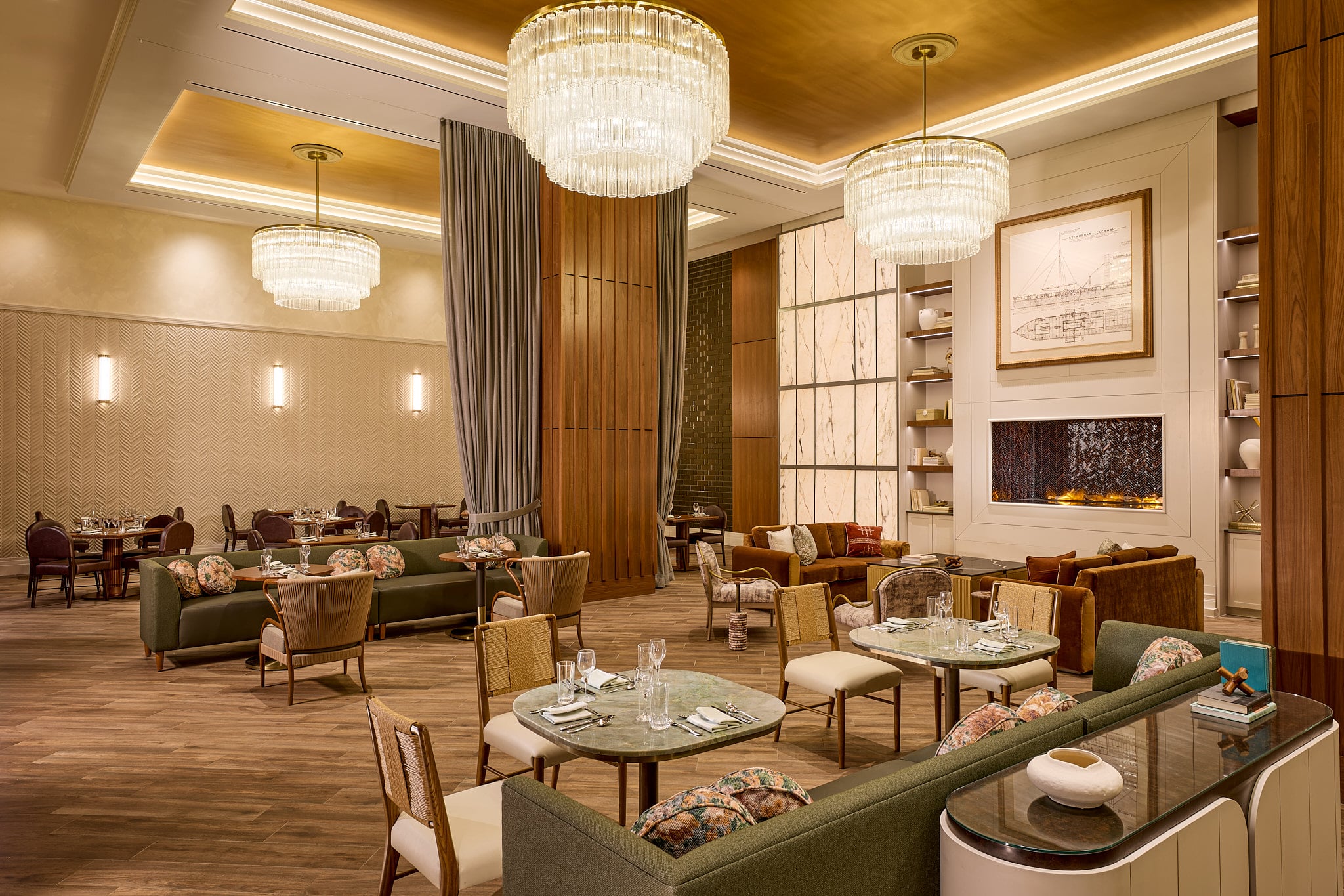 A luxurious restaurant lounge displays diverse seating arrangements for dining and relaxing, featuring grand chandeliers, a fireplace, and a framed blueprint reading "STEAMBOAT CLERMONT".